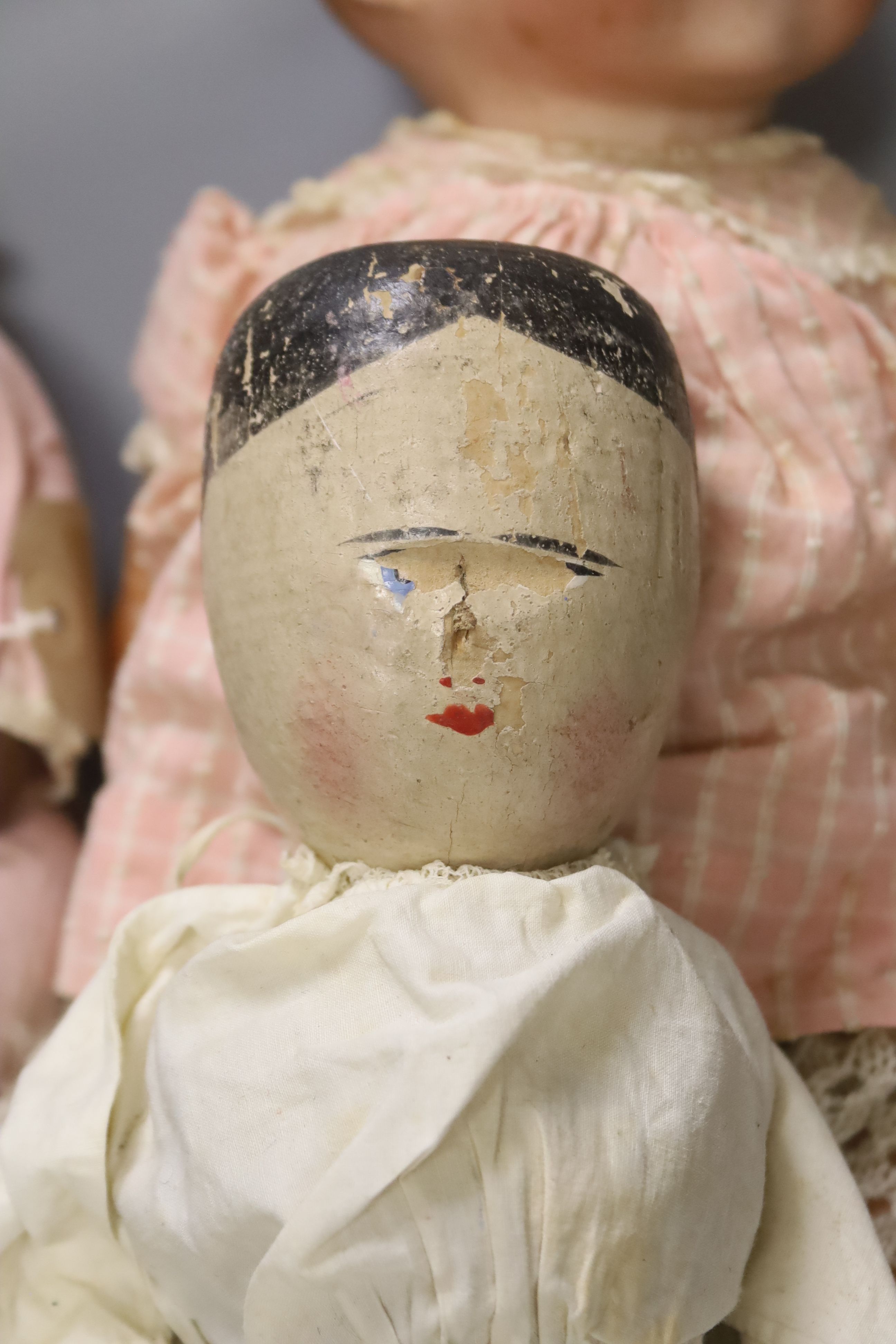 A collection of four dolls including an AM bisque head doll, height 38cm